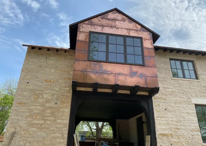 Copper metal panel facade on a stone building for Metal Roof Coating in Maize
